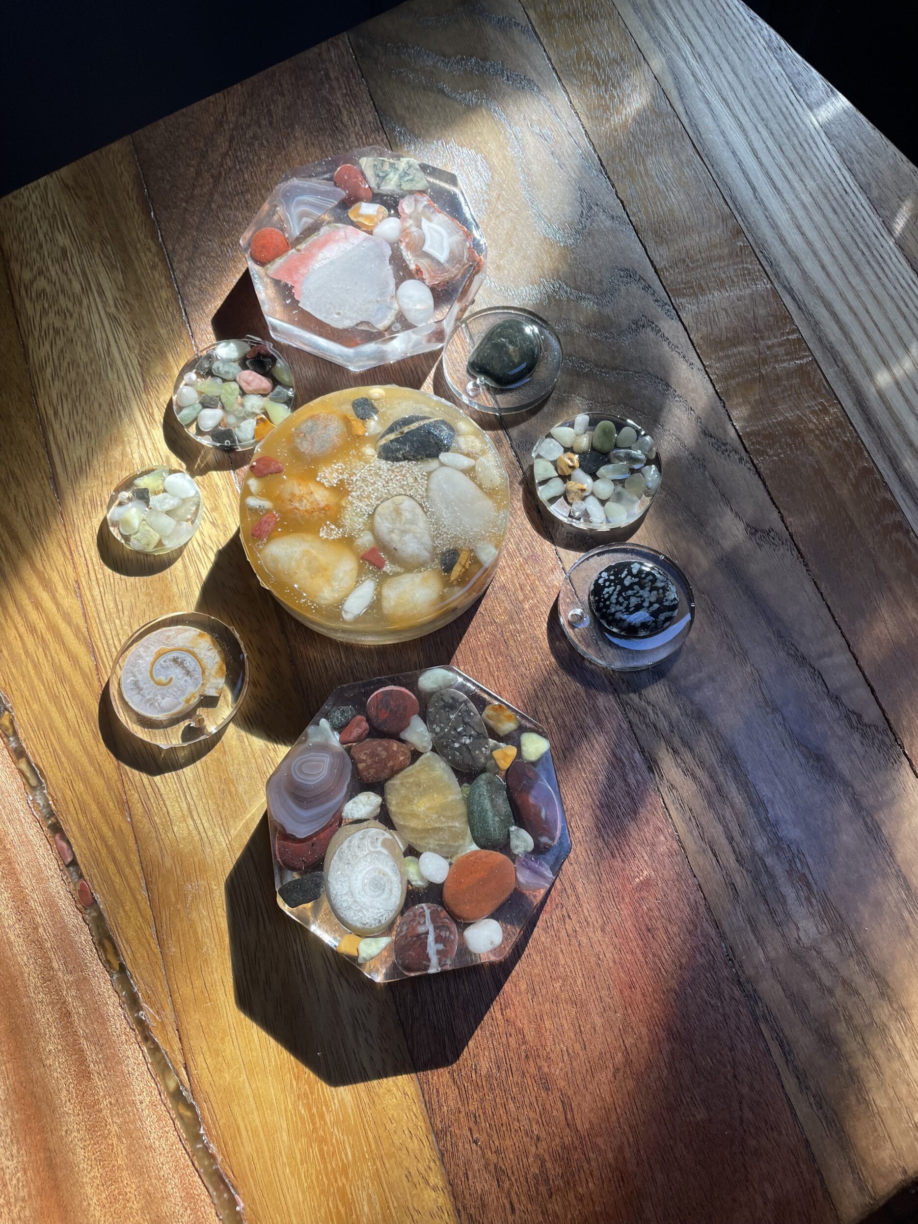 Stones embedded in resin on a wooden background